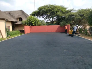 Tar surfacing and brick paving