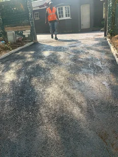 Tar surfacing and brick paving