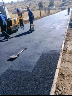 Tar surfacing and brick paving