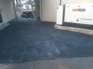 Tar surfacing and brick paving