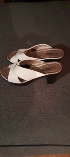 Ladies White Sandals with light - weight black sole and heel. Good as new.