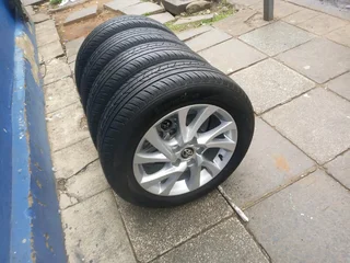 A set of 16inches original Toyota corolla prestige mags 5x114.3 PCD with tyres.Also fit Toyota corol
