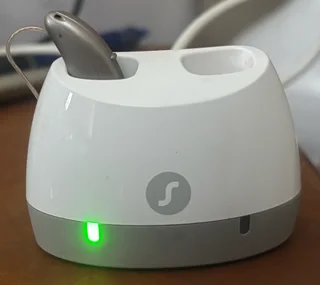 Signia 3Ax [left] hearing aid with accessories