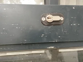 Aluminium framed glass door (negotiable) that comes with handles and keys with dimensions:1,465m wid