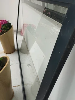 Aluminium framed glass door (negotiable) that comes with handles and keys with dimensions:1,465m wid