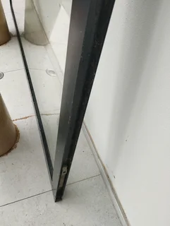 Aluminium framed glass door (negotiable) that comes with handles and keys with dimensions:1,465m wid