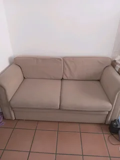 Sell8ng beautiful beige two seater sleeper couch