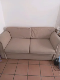 Sell8ng beautiful beige two seater sleeper couch