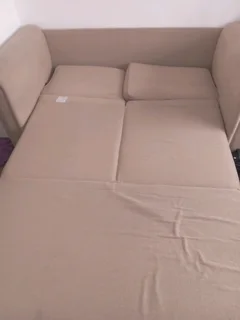 Sell8ng beautiful beige two seater sleeper couch