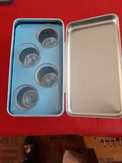 Decorative tin and shot glasses