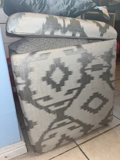 upholstered storage ottoman (patterned fabric, hinged lid).