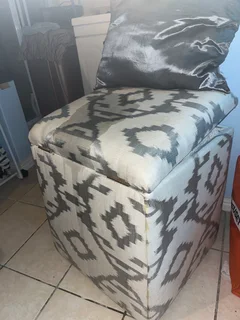 upholstered storage ottoman (patterned fabric, hinged lid).