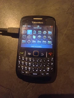 Blackberry cell phone with charger.