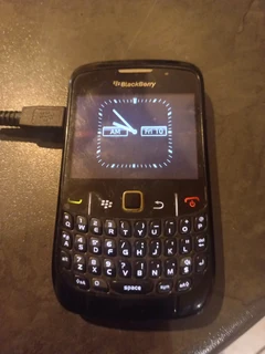 Blackberry cell phone with charger.