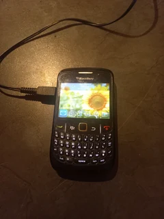 Blackberry cell phone with charger.
