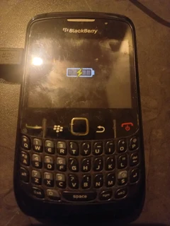 Blackberry cell phone with charger.