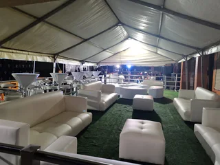 Company closing parties, decor and party hire. VIP lounge decor set up, white couches with cocktails