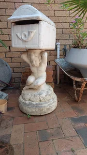 Concrete postbox on statue