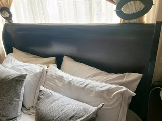 A queen size sleigh bedroom suit  with two pedestals and chest of drawers with a mirror.