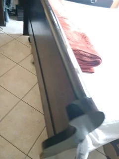 A queen size sleigh bedroom suit  with two pedestals and chest of drawers with a mirror.