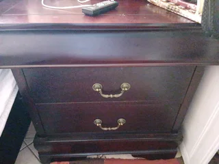 A queen size sleigh bedroom suit  with two pedestals and chest of drawers with a mirror.