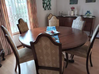 8 seater round dining table with 8 upholstered chairs