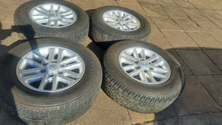 Toyota mags with 265/65R17 Bridestone tires for sale. leave us your whatsapp number for follow up.