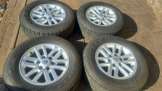 Toyota mags with 265/65R17 Bridestone tires for sale. leave us your whatsapp number for follow up.