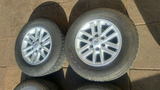 Toyota mags with 265/65R17 Bridestone tires for sale. leave us your whatsapp number for follow up.