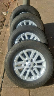 Toyota mags with 265/65R17 Bridestone tires for sale. leave us your whatsapp number for follow up.