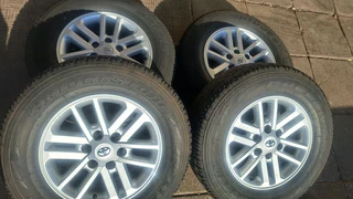 Toyota mags with 265/65R17 Bridestone tires for sale. leave us your whatsapp number for follow up.
