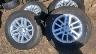 Toyota mags with 265/65R17 Bridestone tires for sale. leave us your whatsapp number for follow up.