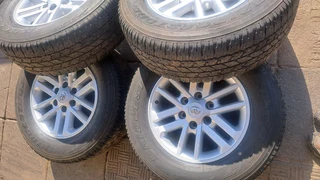 Toyota mags with 265/65R17 Bridestone tires for sale. leave us your whatsapp number for follow up.