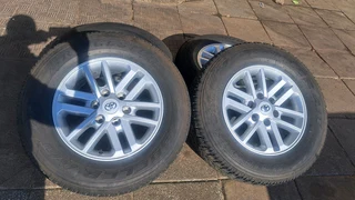 Toyota mags with 265/65R17 Bridestone tires for sale. leave us your whatsapp number for follow up.