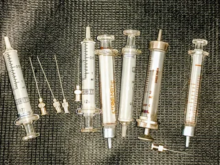 Original glass injections with original screw on needles