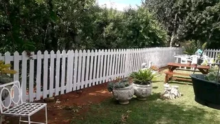 Clean white picket fence and Wood and bamboo fencing
