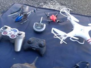 RC DRONES, HELICOPTERS AND CONTROLLS (NOT WORKING)