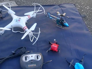 RC DRONES, HELICOPTERS AND CONTROLLS (NOT WORKING)