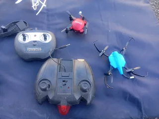 RC DRONES, HELICOPTERS AND CONTROLLS (NOT WORKING)
