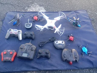 RC DRONES, HELICOPTERS AND CONTROLLS (NOT WORKING)