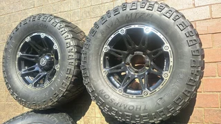 305/65R17 Mickey thompson tires and rims.