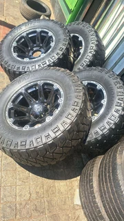 305/65R17 Mickey thompson tires and rims.