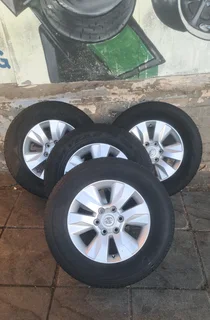 Toyota Hilux rims with 265/65R17 tires. leave your whatsapp number if interested for follow-up.