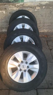 Toyota Hilux rims with 265/65R17 tires. leave your whatsapp number if interested for follow-up.