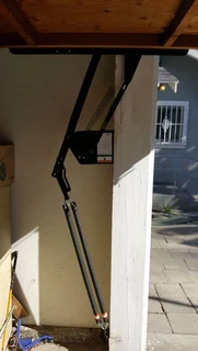 Tip-up garage door hinges