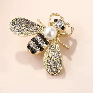 Black and gold brooch