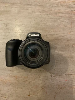 Canon Powershot SX530HS with additional charger and camera bag included.