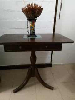 small brown three leggerd table