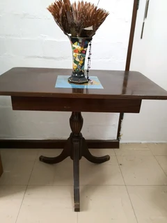 small brown three leggerd table