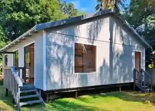 Log Home 10m×8m with 3 Bedrooms, 1 Bathroom, Open plan Kitchen area and Lounge area.